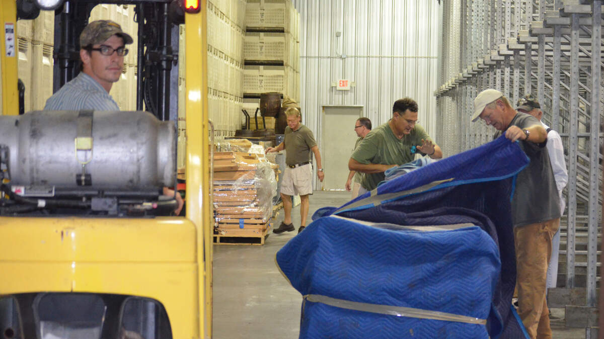 Santa Elena Foundation volunteers unload an exhibit Aug. 16, 2015, after its arrival in Beaufort.