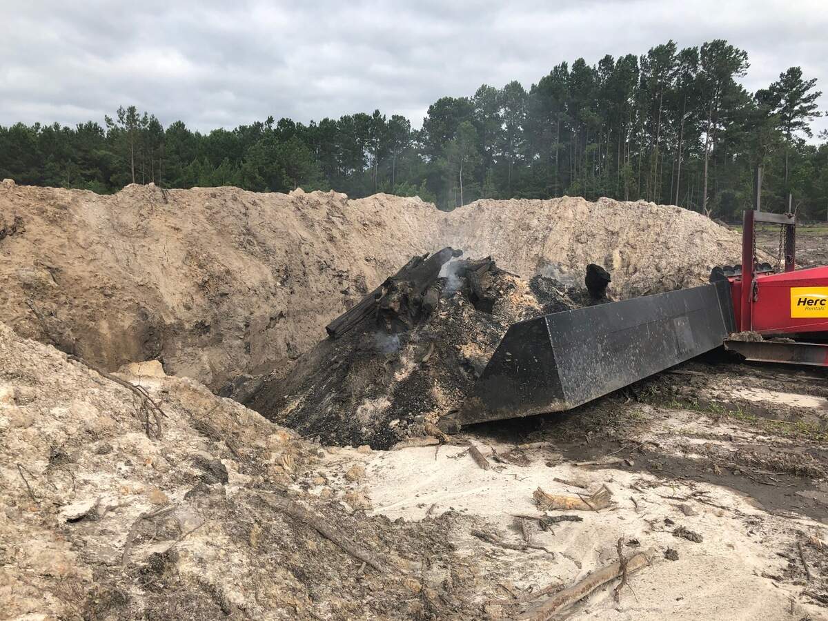 A photo of the burnt pit and enhanced burner used by Dustcom Limited to burn trees after they are cut at the addition to Sun City Hilton Head.