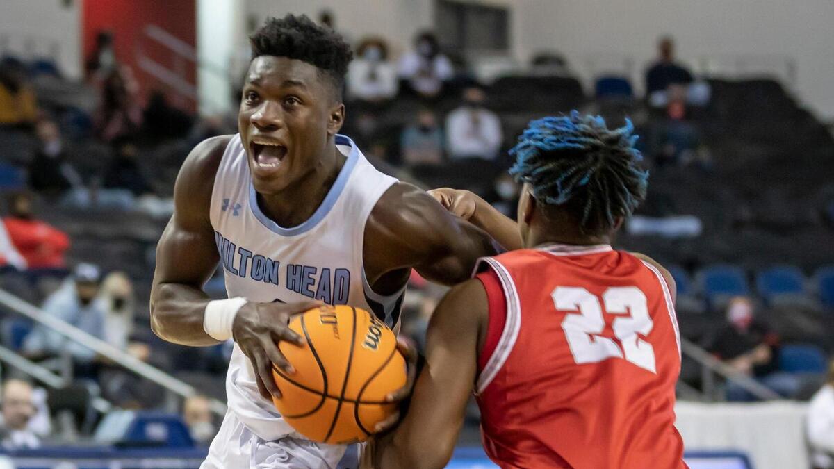 Jaylen Sneed (left) of Hilton Head High School drives through Jalen Hicklin of South Pointe High School during the SCHSL Class AAAA state final game held Saturday, March 6, 2021 at the USC Aiken Convocation Center.