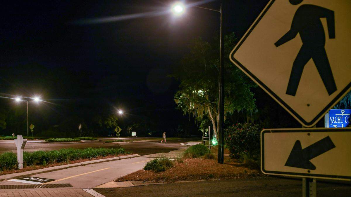 Photographed with a long exposure, a pedestrian crosses U.S. 278 near Yacht Cove Drive on May 1, 2023 on Hilton Head Island. The lights were installed in October 2020 as a pilot project for street lighting after 11-year-old islander Charli Bobinchuck died while crossing U.S. 278 with her dog, Max, in June 2018.