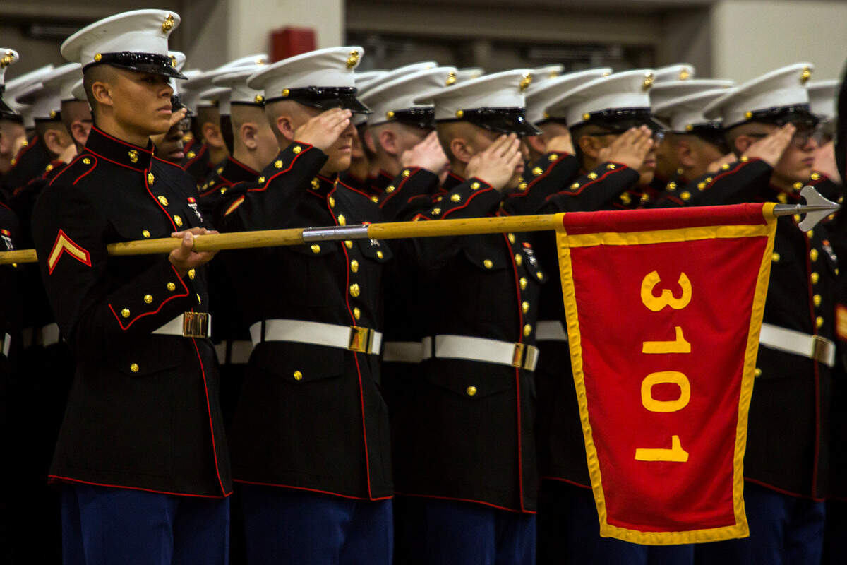 Pfc. Jalen Rooks, a Marine with Kilo Company, 3rd Recruit Training Battalion, holds his platoon’s guidon during his boot-camp graduation ceremony Friday, Dec. 14, 2018, at Marine Corps Recruit Depot Parris Island, S.C.