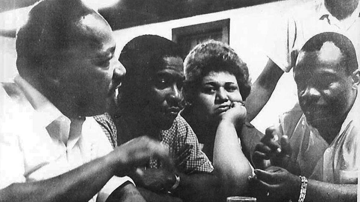 The Rev. Martin Luther King Jr., left, and his associates talk about the civil rights movement at Penn Center on St. Helena Island in the 1960s.