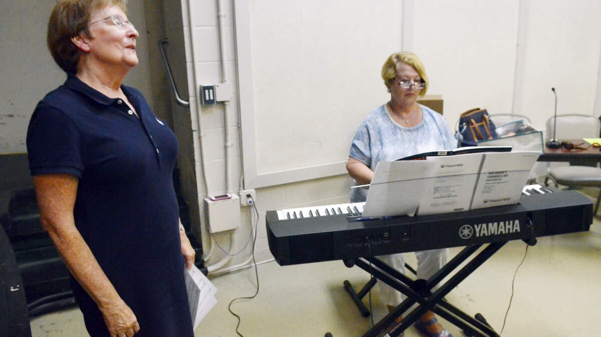 Beth Corry plays piano as Nancy Laws sings a few bars of a song to demonstrate her singing ability during an audition Aug. 25, 2015, for the May River Theatre's upcoming musical.
