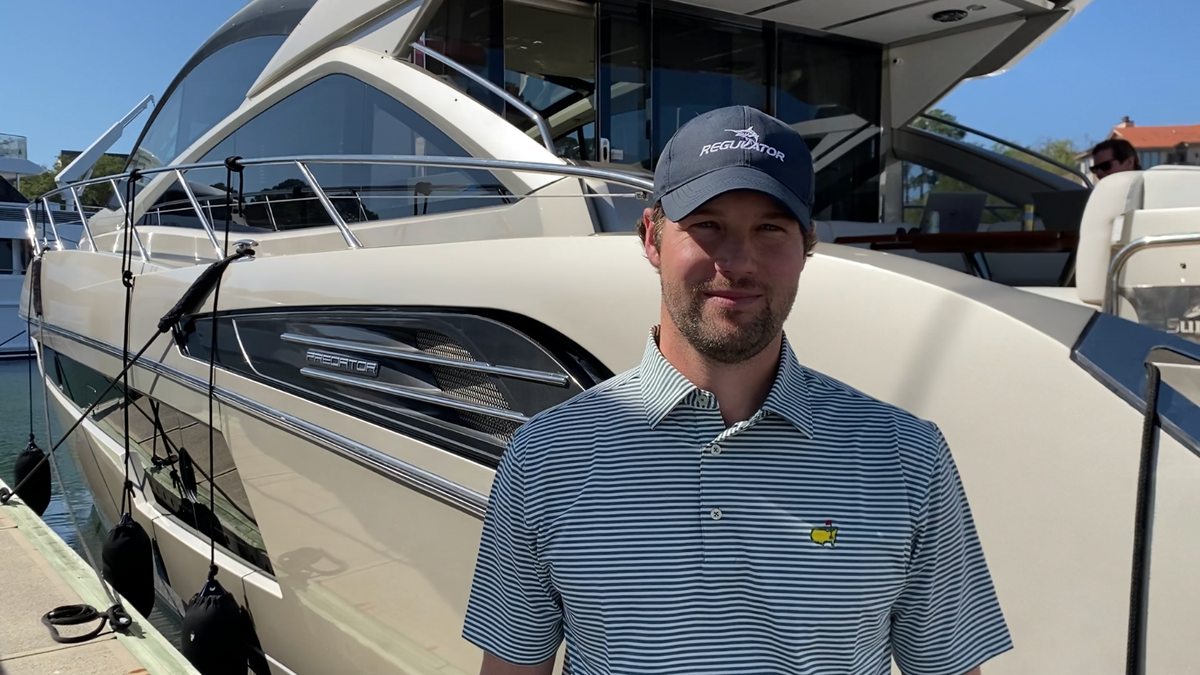 Jamie Lindley, 32, of Savannah stands outside of his family’s 73-foot yacht named Brain Waves docked in the Harbour Town marina on Friday, April 15, 2022.