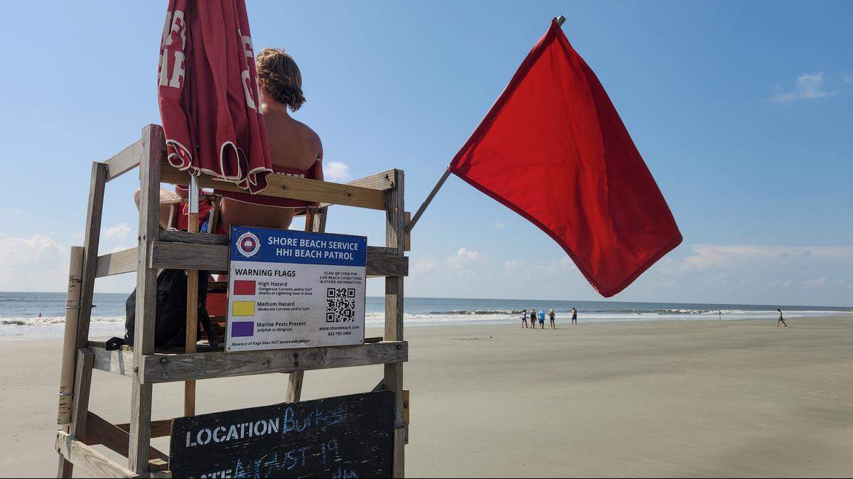 A lifeguard with Shore Beach Service monitors swimmers on Tuesday, Aug. 19, 2025, at Burkes Beach as a red “high hazard” flag flies as Hurricane Erin stirs up the surf on Hilton Head Island.