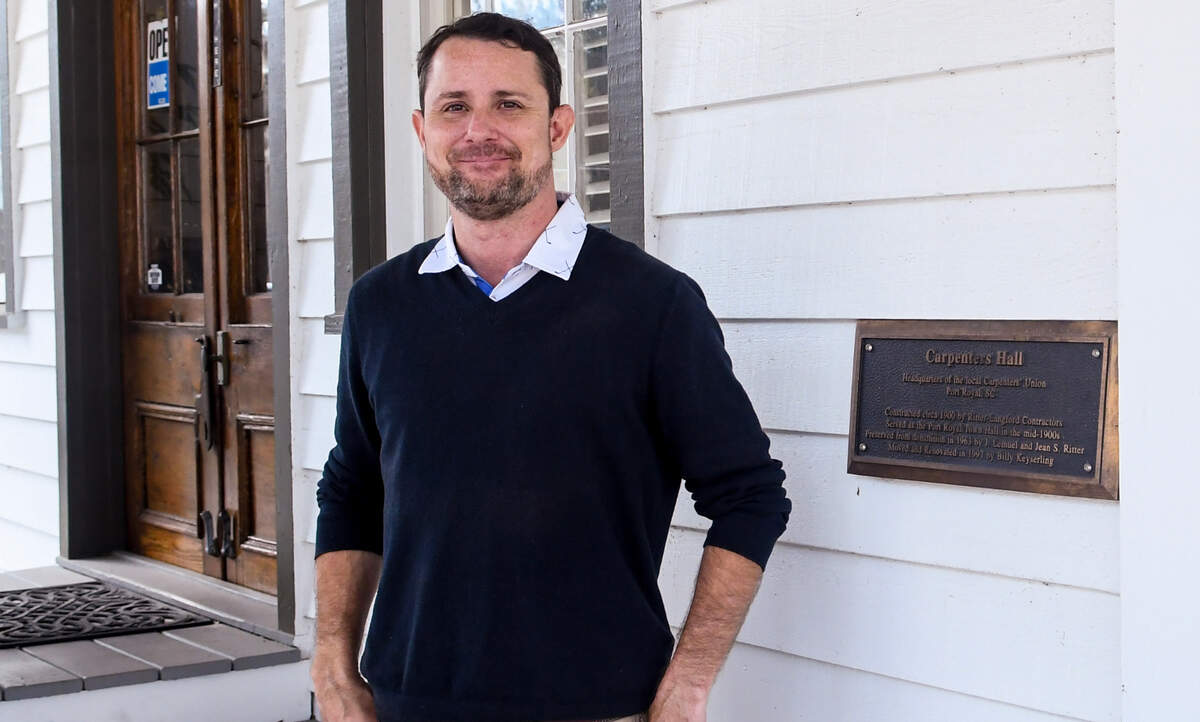Jeremy Taylor, owner of Coastal Real Estate Solutions, stands for a photo in front of his office located in the historic Carpenter’s Hall on Oct. 27, 2022 in the Town of Port Royal. Taylor had his first experience with the building’s spirit as he was talking about renovations with the previous owner and a book fell to the floor.