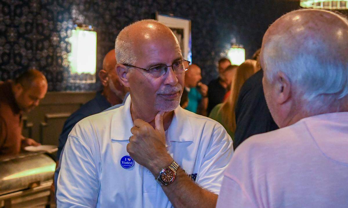 Joey “JoJo” Woodward Jr. speaks with a supporter at Frankie Bones in Bluffton on Tuesday, June 14, 2022. Woodward lost the election after unofficial results finally were released at 12:51 a.m. Wednesday morning.