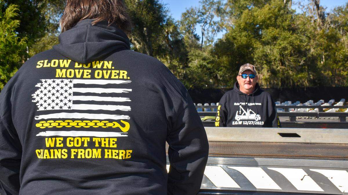 Employees with A1 Towing wear hoodies commemorating the life of former employee and 12-year Marine Veteran Eric Albertson on Wed., Jan. 10, 2024 at Beaufort National Cemetery.