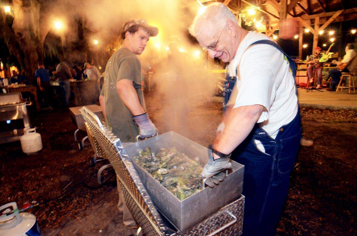 Chuck Weickhardt and his grandson, PJ Kopenhaver, keep the fresh-steamed oysters coming on Saturday night during the annual Zonta Club of Beaufort Oyster Roast. Organizers expected to steam 33 bushels of fresh local oysters at the event, held at Live Oaks Park in Port Royal, to raise funds for Zonta Club charities.