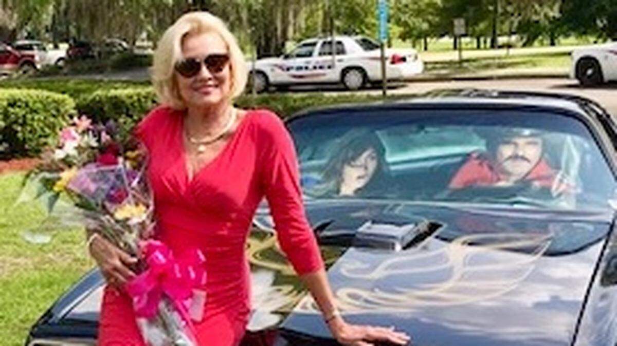 Simone Griffeth of Bluffton poses on a Burt Reynolds Pontiac Trans Am at the RKDS Film Fest in Valdosta, Ga., in July, which she and Reynolds headlined.