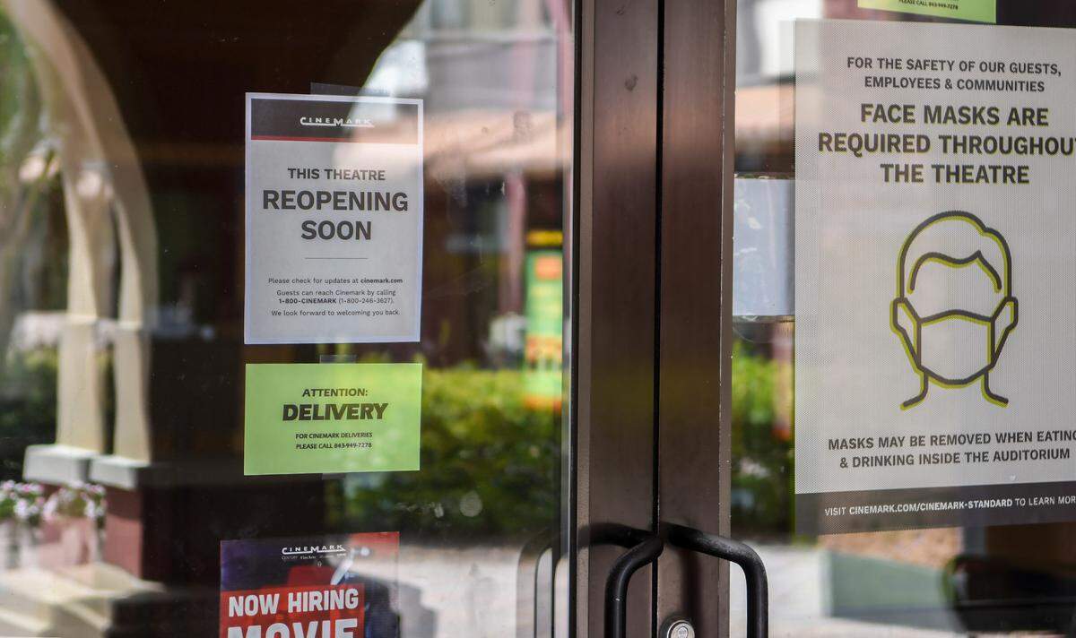 Signs posted on the doors and in the movie poster boxes inform customers that the Cinemark located in Berkeley Place in Bluffton will soon open with new procedures to combat the spread of the coronavirus. According to the website, the theater will reopen Tuesday, Aug. 25, 2020.