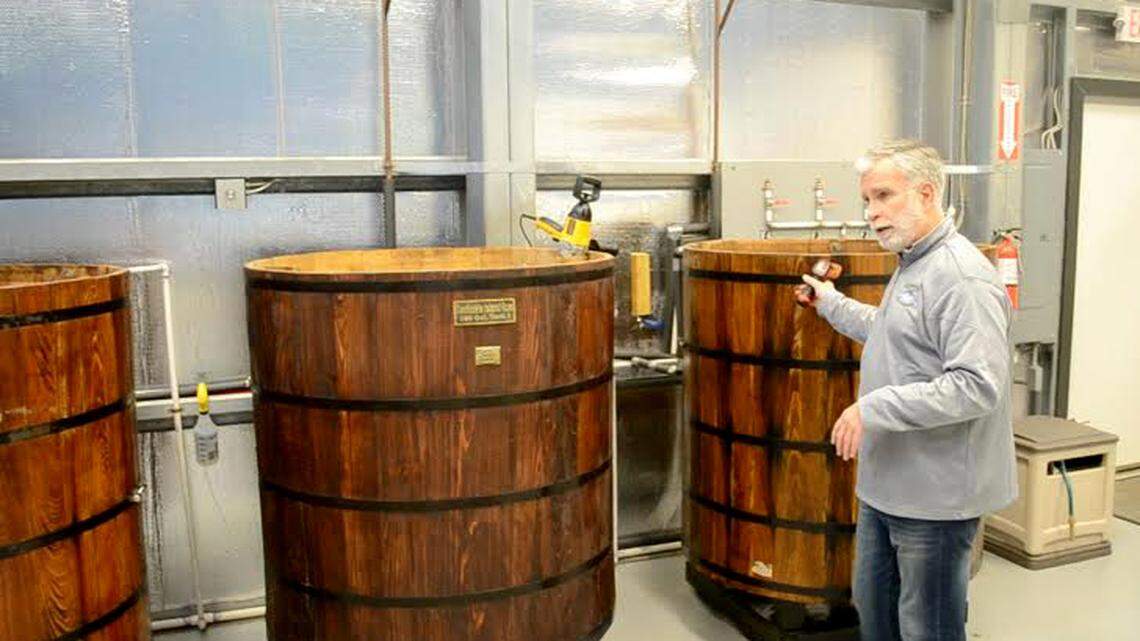 Tony Chase, owner of Daufuskie Island's Rum Company, holds a bottle of one of his products.