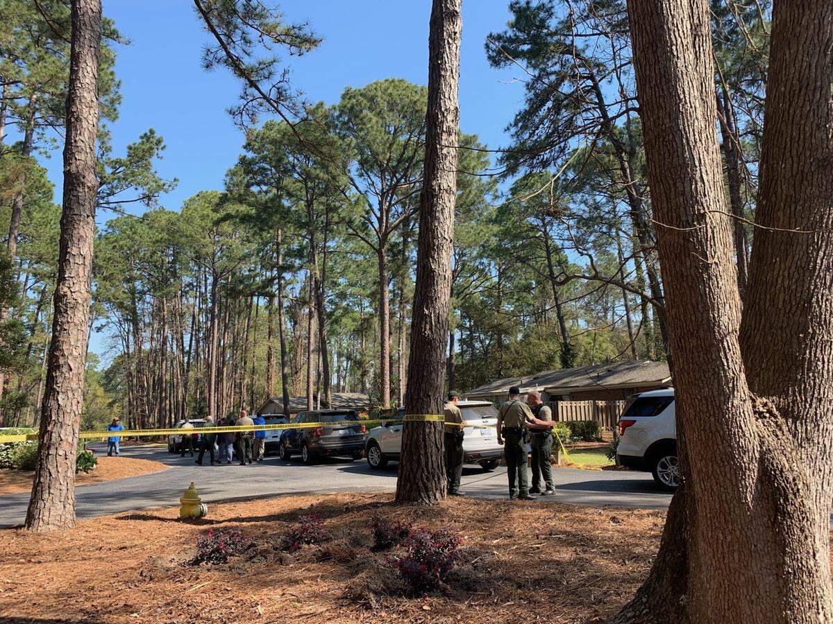 Beaufort County Sheriff’s Office deputies stand Thursday outside Point Comfort Club Villas on Hilton Head Island where 44-year-old Karma Young was shot.