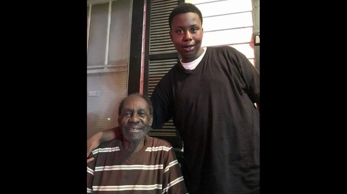Taequan Mitchell, a student at Savannah High School, is photographed with his neighbor, 85-year-old Samuel Solomon.