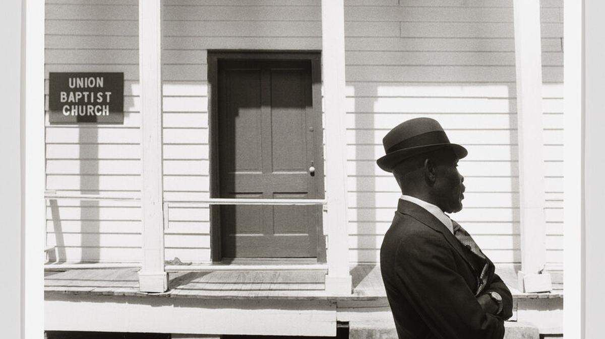 Jeanne Moutoussamy-Ashe, A Man Standing in Front of Union Baptist Church, Daufuskie Island, SC, 1979, printed 2022. Gelatin silver print, 16 1/4 × 22 3/8in. (41.3 × 56.8 cm). Whitney Museum of American Art, New York; purchase with funds from Donna Perret Rosen and Benjamin M. Rosen 2023.114.4. © Jeanne Moutoussamy-Ashe