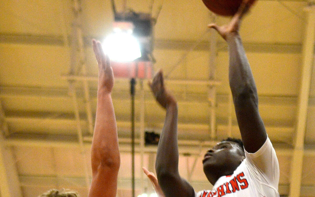 Hilton Head Prep's Kwame Agyei-Minta, right, tries to shoot the ball during a game against Thomas Heyward Academy on Friday night at Hilton Head Preparatory School on Hilton Head Island.
