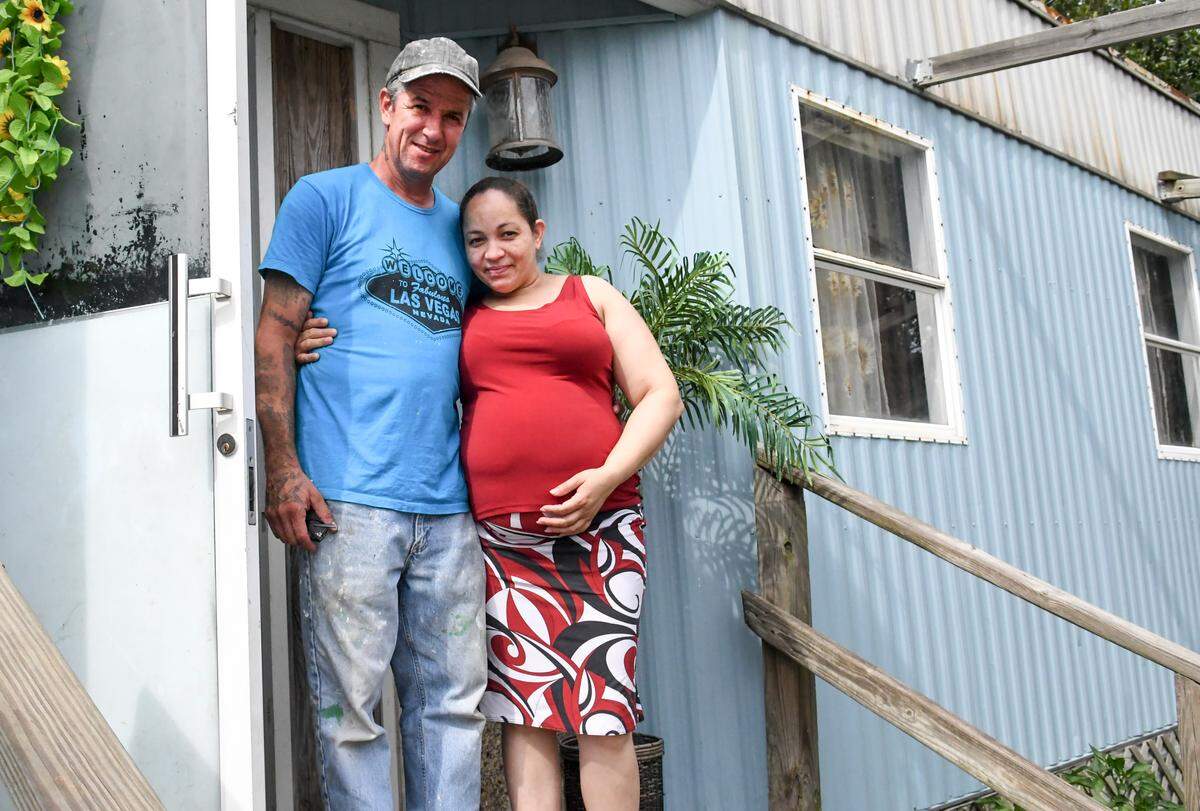 Less than 200-feet from the toxic smoke spewing from Able Contracting’s Material Recovery Center, Timothy O’Leary and Jenny Valdez stand for a portrait on Thursday afternoon on the porch of the mobile home they rent. On Wednesday evening, their landlord, Hampton Lloyd called 911 after Valdez complained of breathing problems. Valdez was taken to Coastal Carolina Hospital for evaluation where the attending physician wrote that the couple should leave their home for the sake of their health and that of Valdez’s unborn baby.