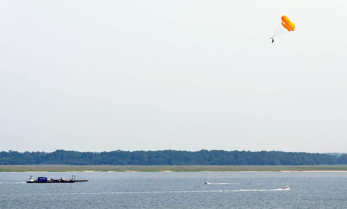 Water traffic on Calibogue Sound, including a parasailer, passes off the wooded shore of Bull Island on Wednesday in this view taken from atop the Harbour Town Lighthouse.