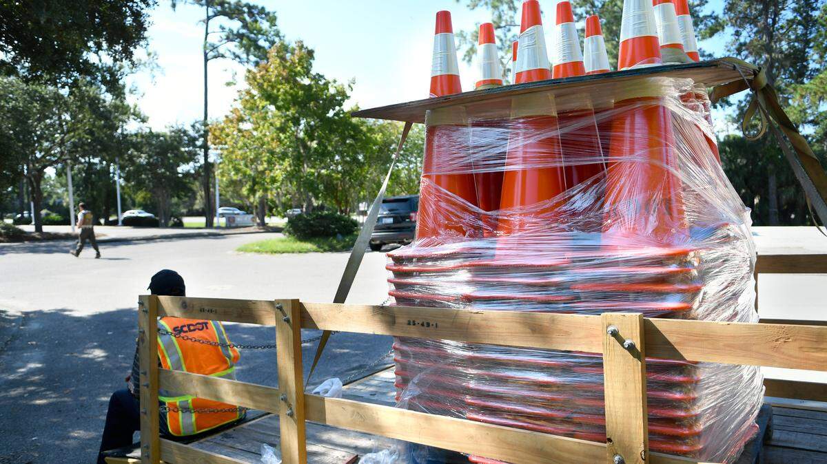 Traffic cones, stacked on the back of a South Carolina Department of Transportation trailer, are seen on Tuesday morning in a staging area off of US 278 just before the bridges to Hilton Head Island. Workers arrived at 7 a.m. and were positioned along the entire stretch of the highway from Hilton Head to Interstate 95 for the possibility of converting an eastbound lane for westbound traffic if the highway became too congested. At 11:30 a.m., the governor called off the mandatory evacuation for Beaufort, Jasper and Colleton counties after Hurricane Florence’s path was maintaining a North Carolina landfall.