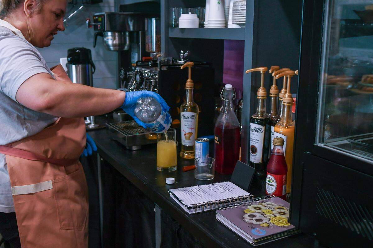 Proprietor Erica Ashby prepares to make a piña colada mocktail on Aug. 16, 2023, at her store Cupcakes 2 Cakes located in Berkeley Place in Bluffton. Ashby plans to offer mocktails paired with desserts for after-movie or after-dinner treats.