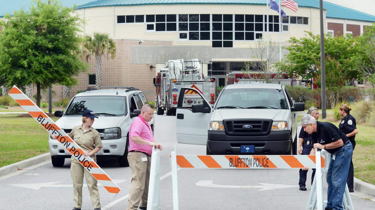 In this file photo, police officers barricade the entrance to Bluffton High School during a May 1, 2013, lockdown after then-17-year-old Austen Almeida brought a loaded gun and knives to the school.
