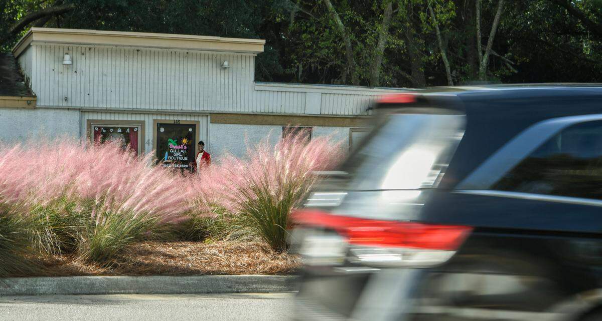 Tressa Govan, owner of Tressa’s Gullah Girl Boutique, stands for a portrait on Thursday, Oct. 22, 2020 outside of her store as U.S. 278 traffic barrels by the store on Hilton Head Island. Govan’s store is at risk of being in the path of S.C. Department of Transportation’s plan to widen U.S. 278 with another two lanes. “I’d be heartbroken if they tear by building down” Govan said after giving a tour of her shop’s fashions and accessories.
