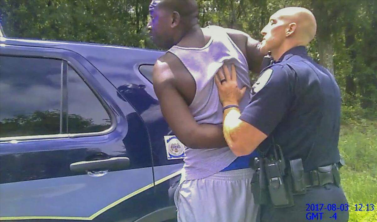 The body cam of Bluffton Police Officer Amber Swinehamer on Aug. 3, 2017, shows the moments before fellow officer Cody Kirkman, right, picks up and drops Bluffton resident Teddy Ellis on the pavement after an Automatic License Plate Reader alerted Kirkman that Ellis’ vehicle registration was suspended.