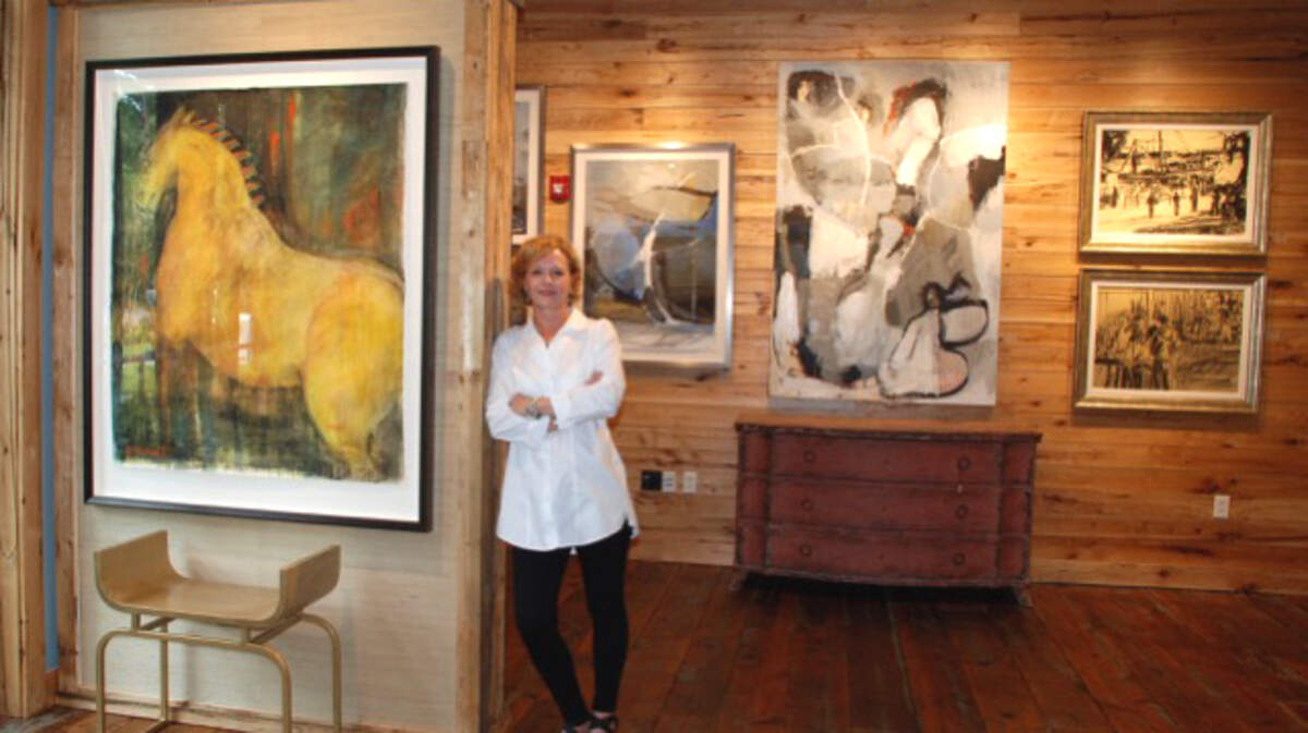 Owner/director Adrianne Lively poses inside the Camellia Art and Gallery.