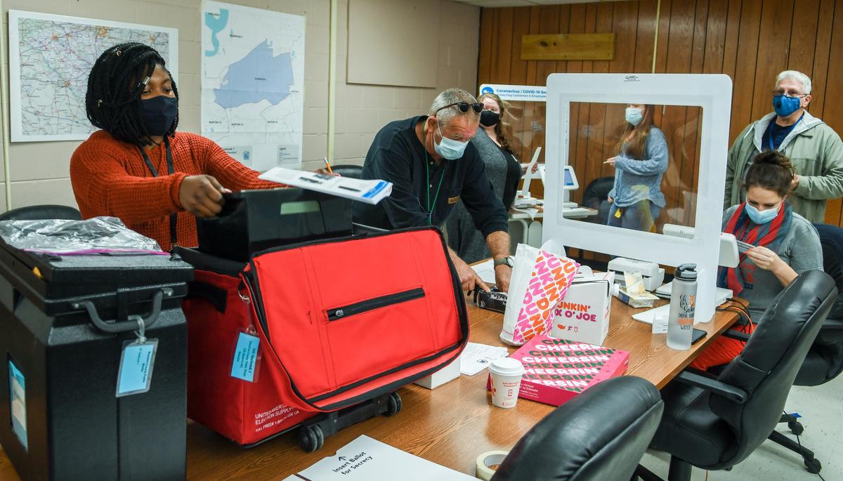 In this file photo, a poll worker at the Beaufort County Public Works building checks in a voter as others prepare for other residents in the general election on Tuesday, Nov. 3, 2020 in Seabrook.