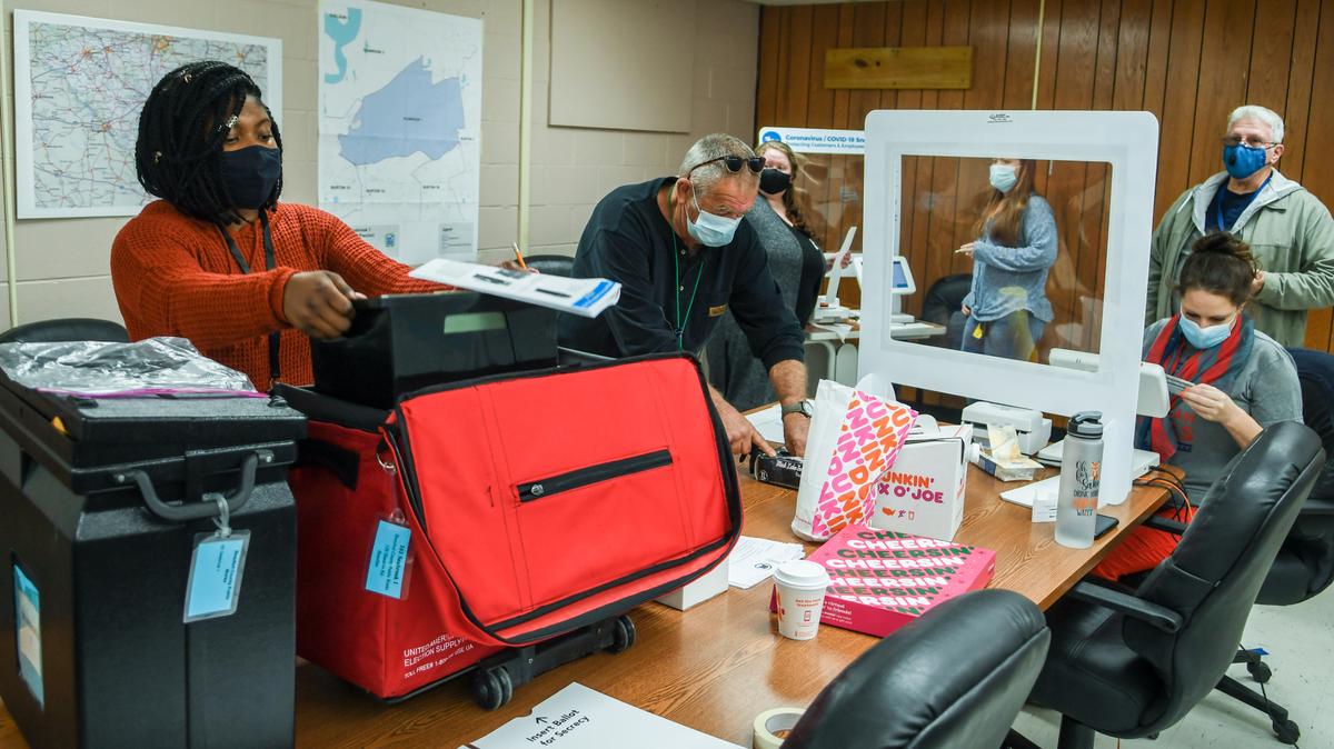 In this file photo, a poll worker at the Beaufort County Public Works building checks in a voter as others prepare for other residents in the general election on Tuesday, Nov. 3, 2020 in Seabrook.
