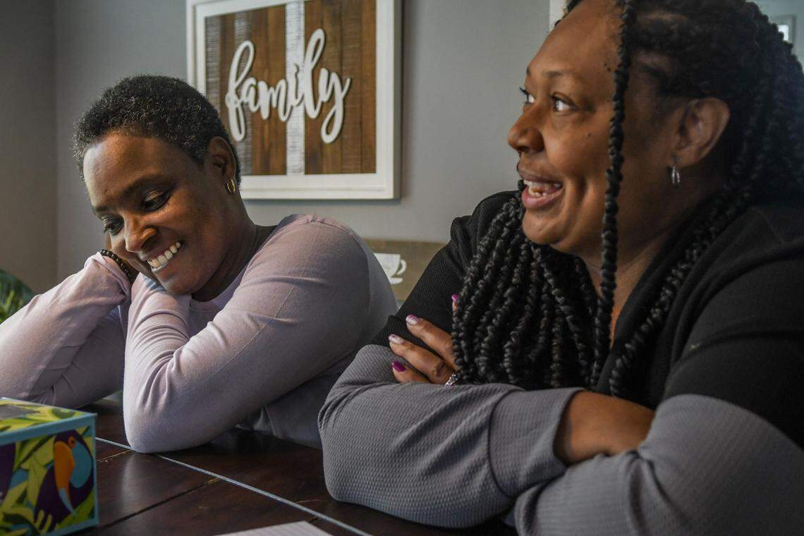 Consweulo Davis, left, and Linda Davis’ oldest sister, Andrea Chang, share stories about Linda on March 3, at the Davis’ home in Pooler, Ga.
