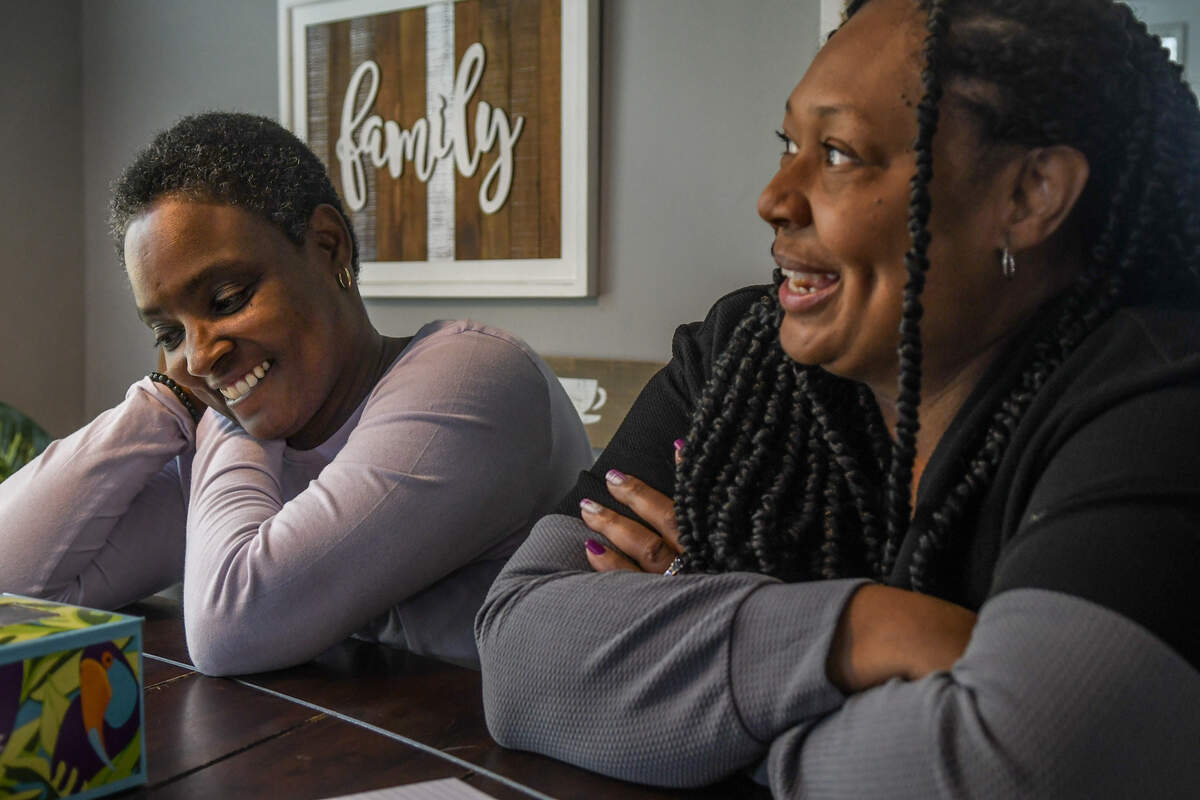 Consweulo Davis, left, and Linda Davis’ oldest sister, Andrea Chang, share stories about Linda on March 3, at the Davis’ home in Pooler, Ga.