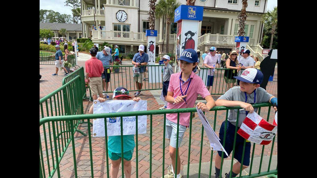 Three children show off their autographed RBC Heritage Presented by Boeing flags on Thursday, April 14, 2022 at the Harbour Town Golf Links on Hilton Head Island, S.C.