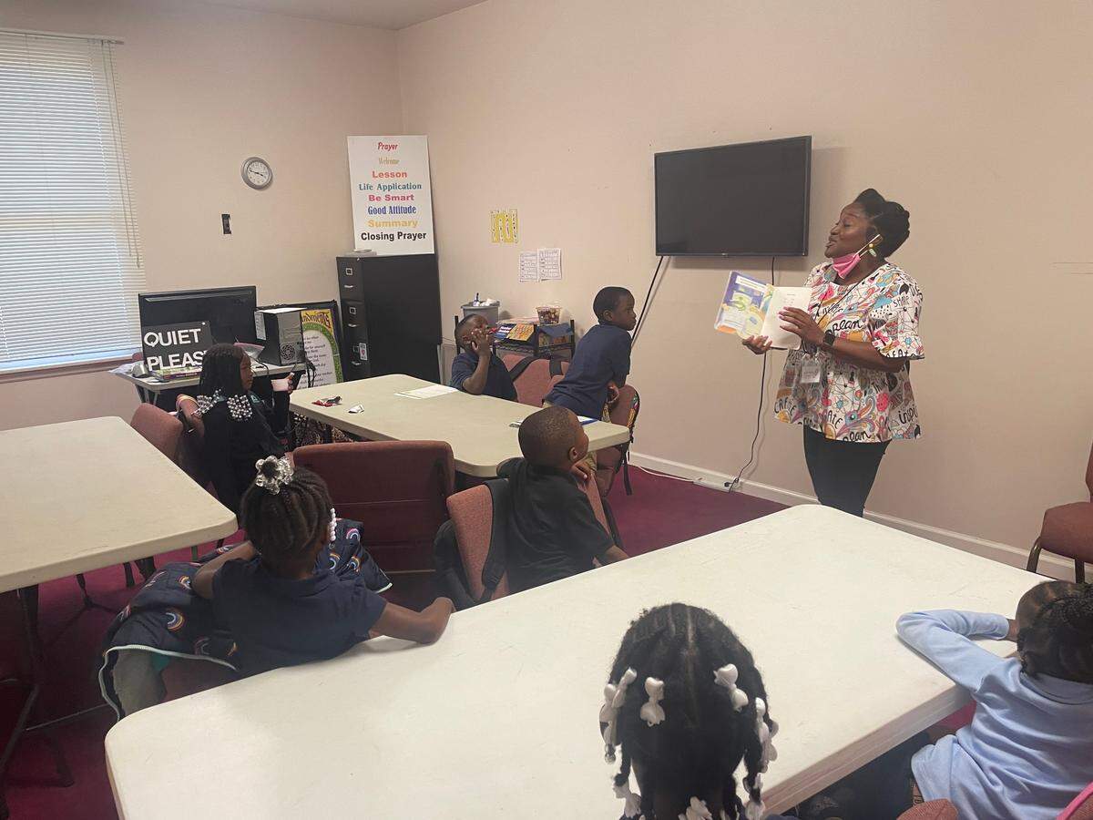 April Smalls reads a book to her extended learning program students.