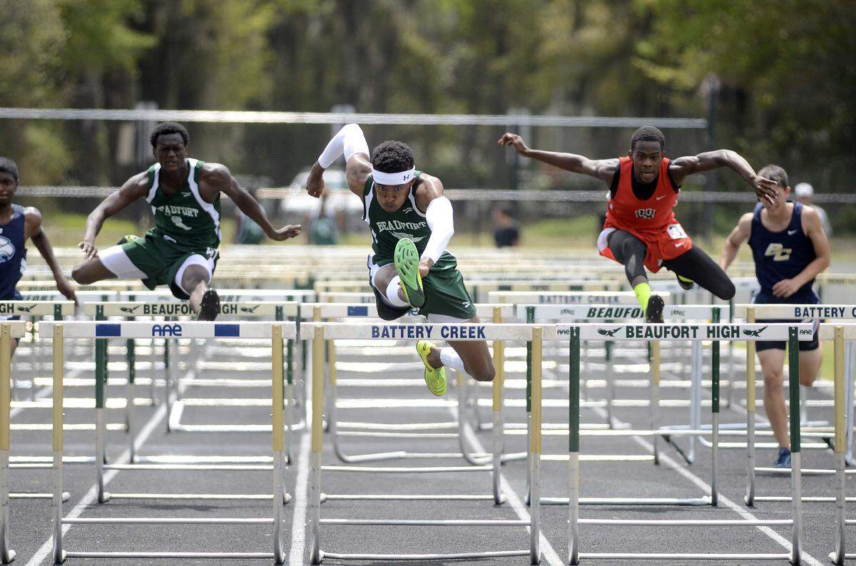 Beaufort High School’s Michael Dickson, center, leads during the 110-meter hurdles race on April 5 during the Beaufort Track Classic at Beaufort High School. Dickson placed first in the event.