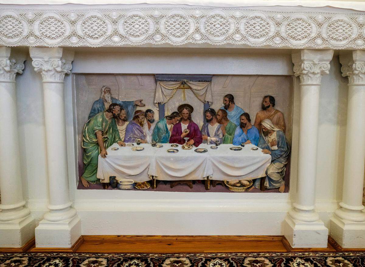 A hand painted scene from the Last Supper shows great dimension by its painted shadows at St. Peter the Apostle Catholic Church on Carteret Street in Beaufort.
