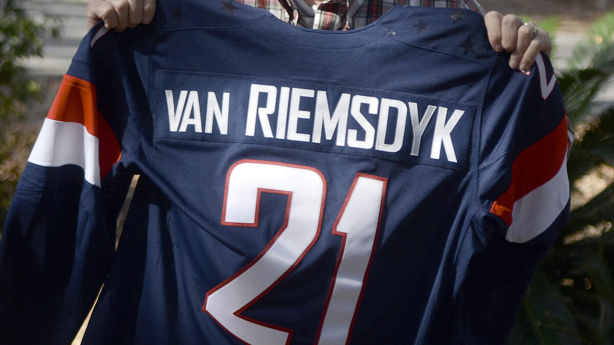 Frits van Riemsdyk holds his grandson's, James van Riemsdyk, hockey jersey Feb. 17, 2014, at The Island Packet's office in Bluffton.  James van Riemsdyk is a member of the 2014 USA Olympic Men's Hockey team.