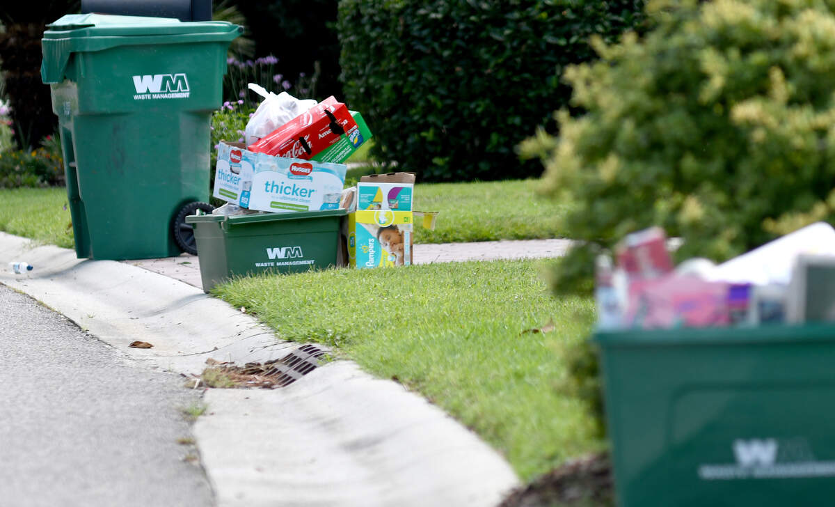 Recyclable bins sit curbside along Crossings Boulevard in the Bluffton neighborhood of Pinecrest on Tuesday awaiting recyclable collection by Waste Management.