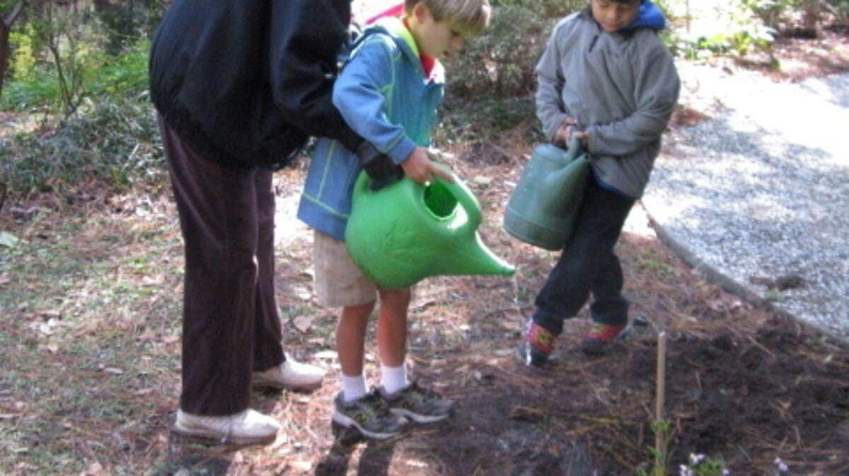 Marion Gosson, Xeriscape Garden Tour Leader, planting Georgia Mint and 'Paper Whites' with students from Hilton Head Island School for The Creative Arts. 