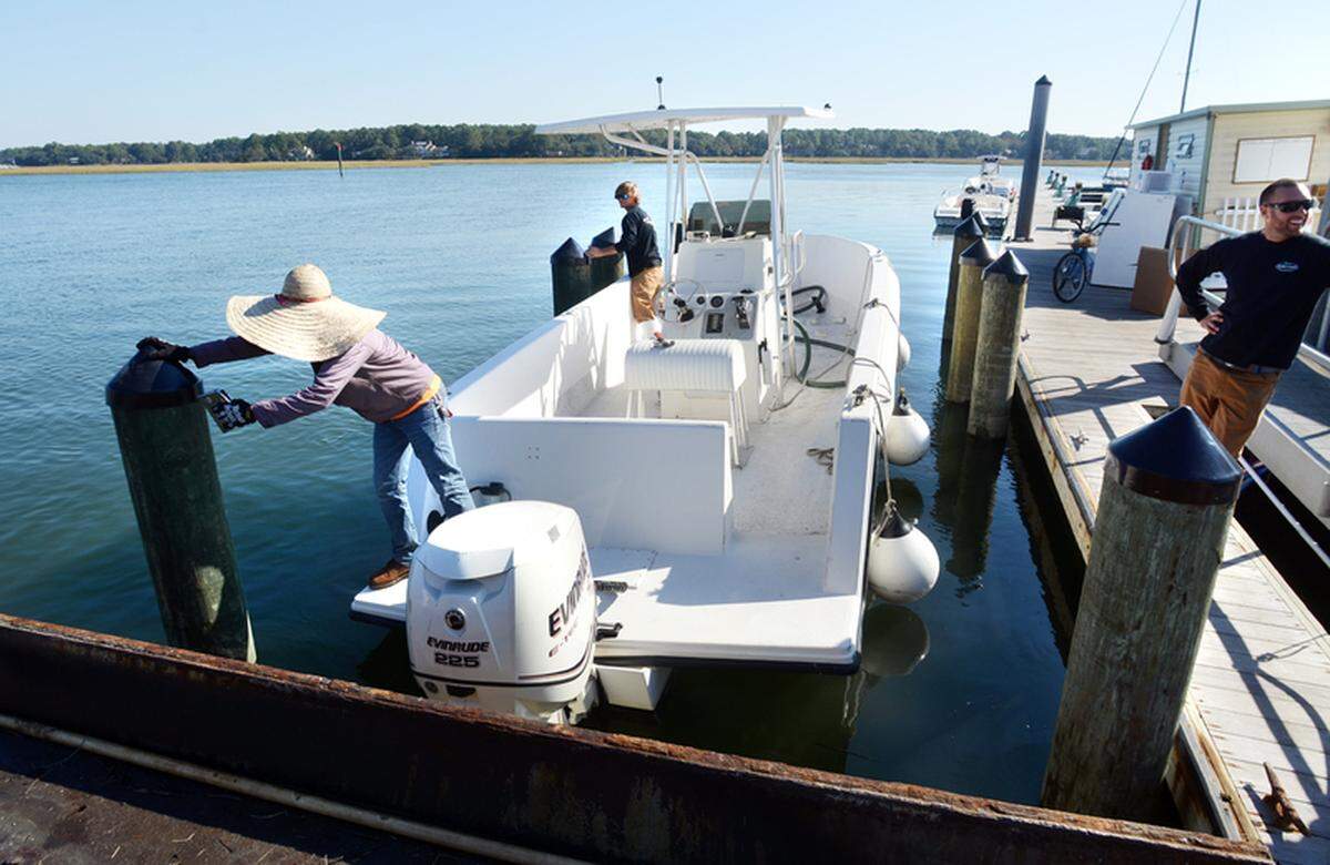 Broad Creek Marina employees put caps on pilings for a boat lift under construction at the marina in 2012.