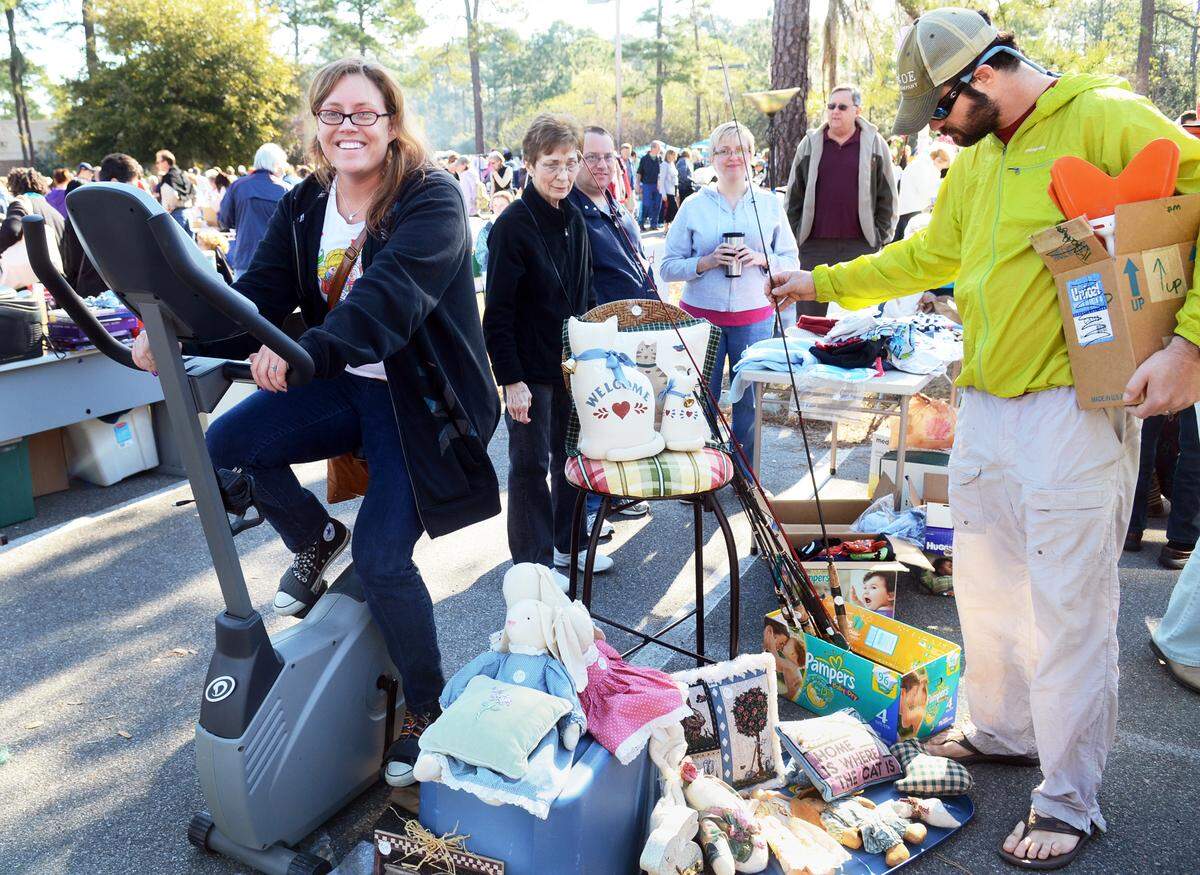 Beaufort’s Lori Heindel takes a break from shopping for bargains to ride an exercise bike on display at a previous World’s Largest Yard Sale in the Hilton Head Island High School parking lot.