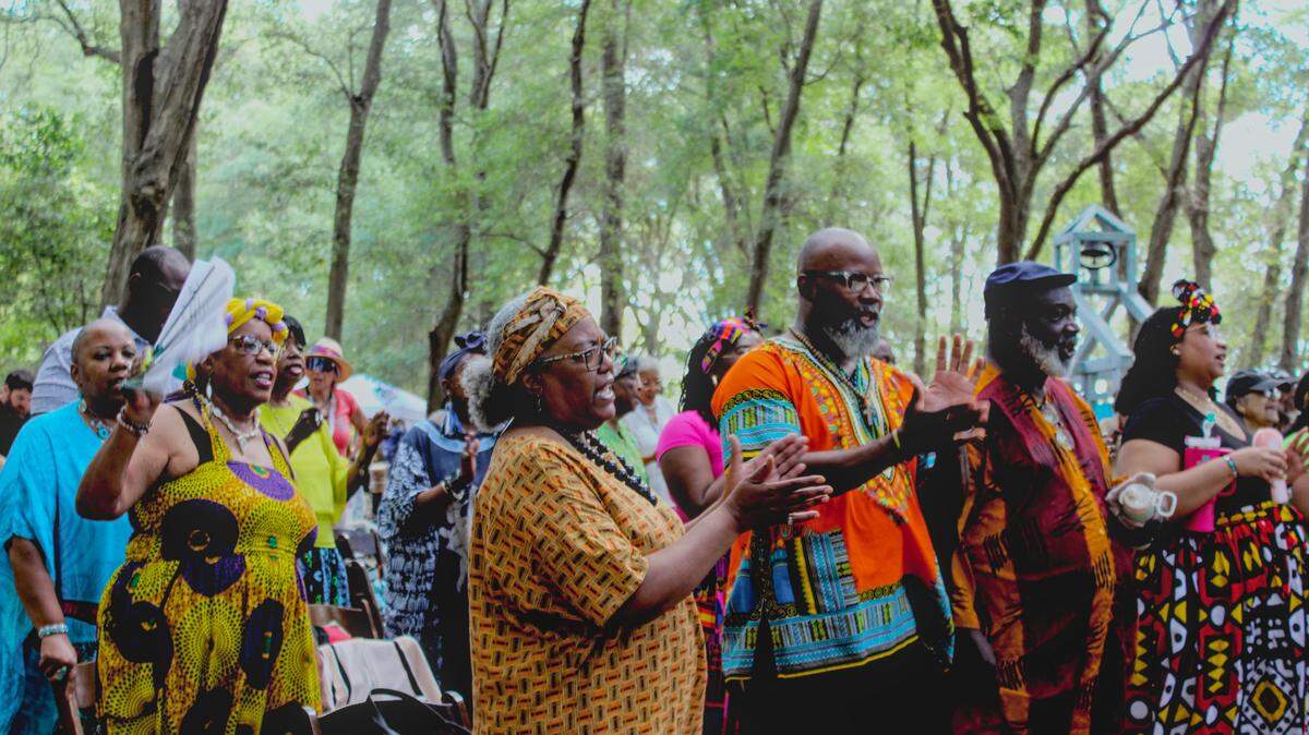 Juneteenth celebrators don African textiles and clap along to gospel music at Historic Mitchelville Freedom Park on June 14, 2025.