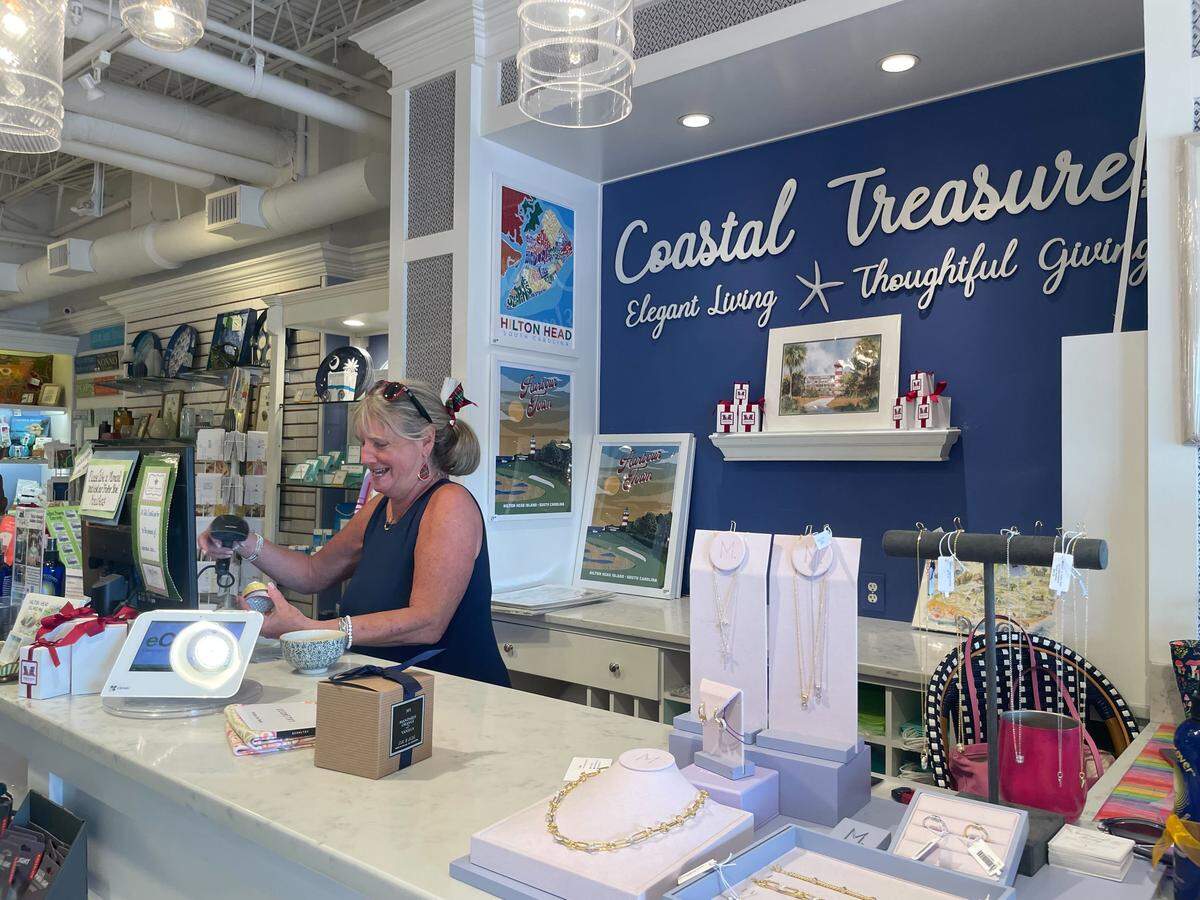 Donning a plaid hair bow and earrings, Kathy Kaess, who manages a gift shop called Coastal Treasures in Harbour Town, said she’s been “stocking up” to prepare for the Heritage crowds