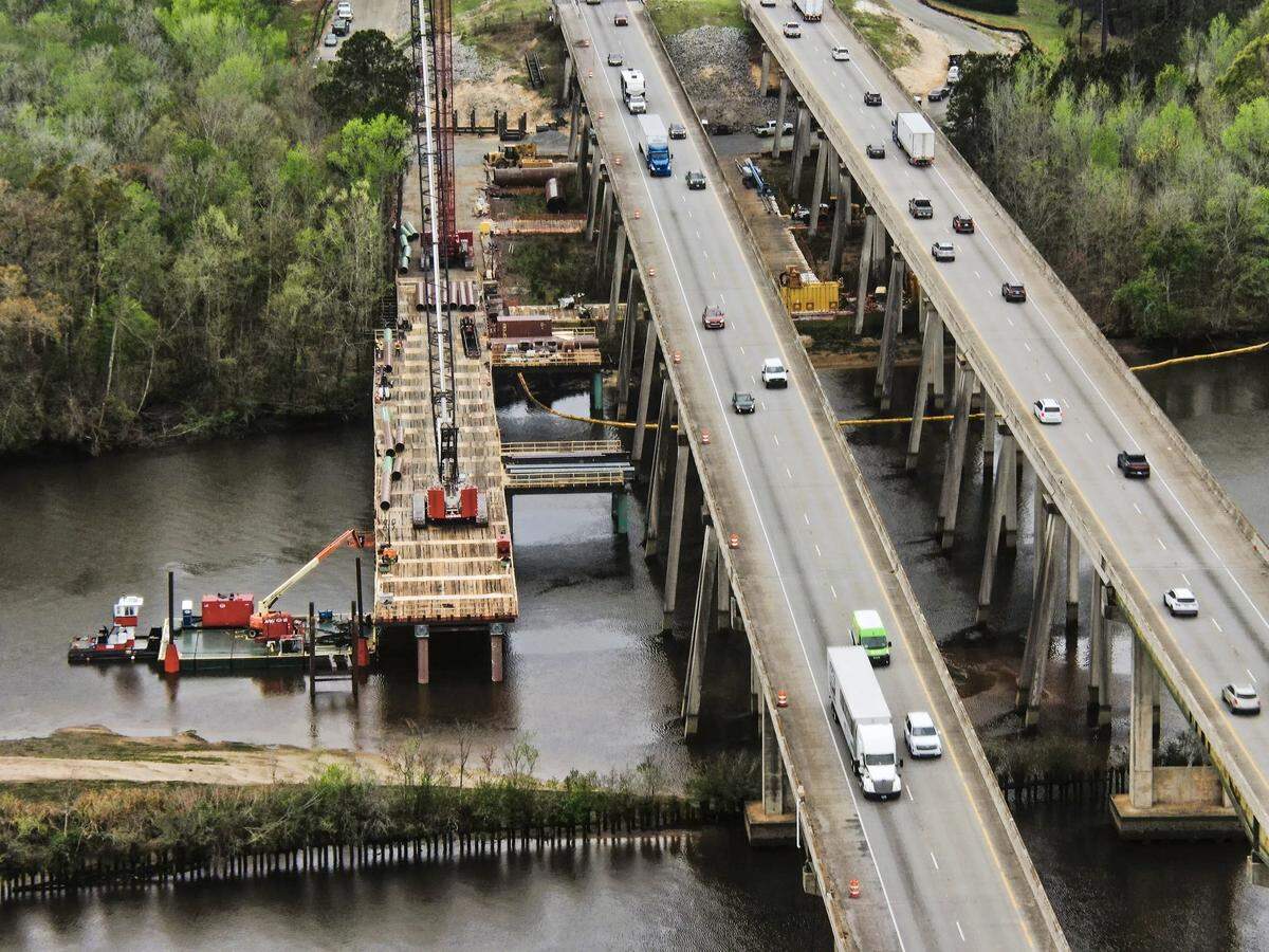 In this undated photo from SCDOT’s “fixthedrive95” website, crews construct a platform which will allow them to build footings for a new bridge on the outer perimeter of the northbound bridge on Interstate 95 over the Savannah River into South Carolina.