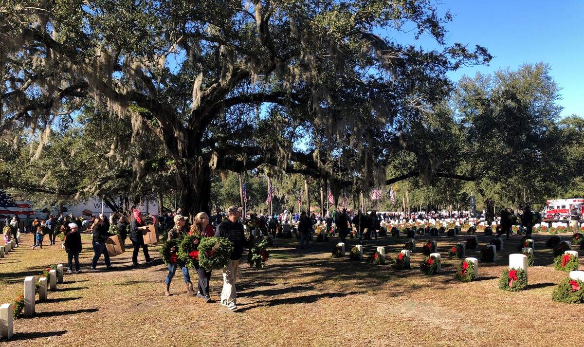 Volunteers fan out across Beaufort National Cemetery placing remembrance wreaths on headstones as part of a Wreaths for America event Dec. 14, 2019.
