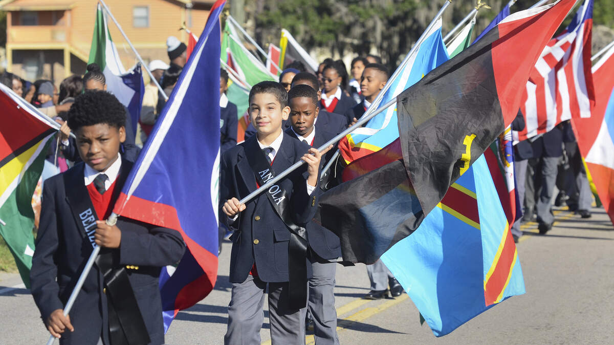 Children bearing the flags of the Gullah people march in the 33rd Annual Heritage Days parade on Saturday on St. Helena Island. 