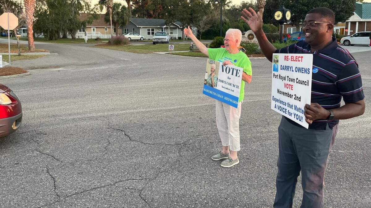 Mary Beth Gray Heyward and Darryl Owens, candidates for Port Royal Town Council, campaign near Town Hall 30 minutes before the polls closed at 7 p.m. Tuesday evening.