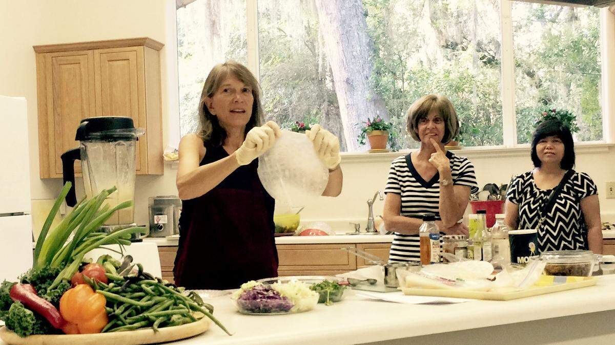 Karen Holland of Hilton Head Island demonstrates how to use rice paper to make spring rolls using red cabbage, jicama and fresh herbs Monday at the Whole Foods, Plant-Based Supper Club at the Seventh-Day Adventist Church on Hilton Head.