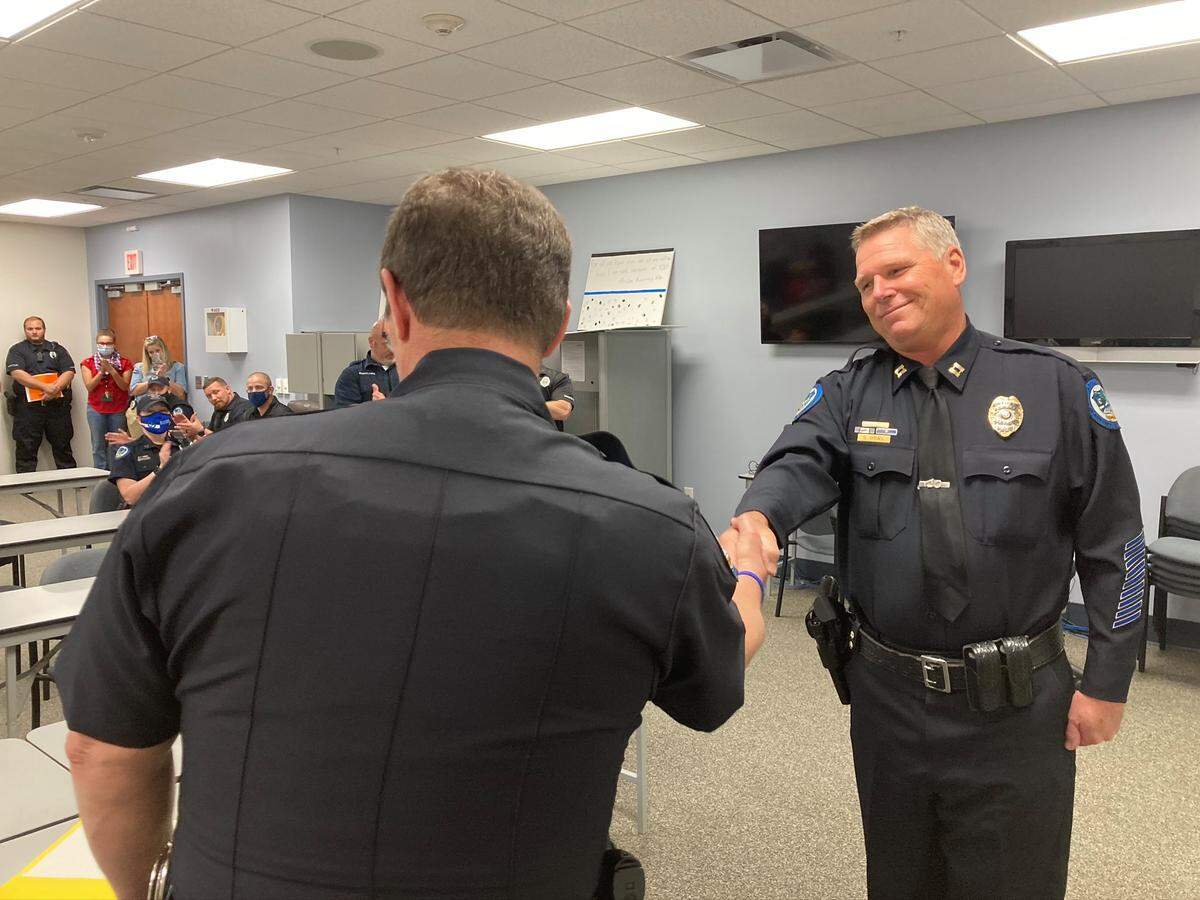 Beaufort Police Chief Dale McDorman shakes newly sworn-in Deputy Chief Darrell Gruel’s hand.