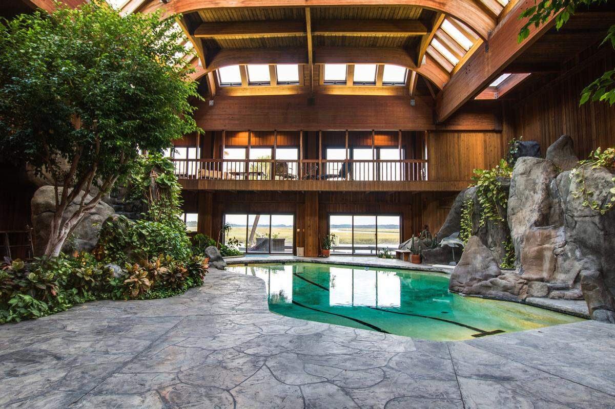 An old photo of what the wood atrium looked like before renovations. The pool has since been filled in, and the windows redone to give a clearer view of the outdoors.